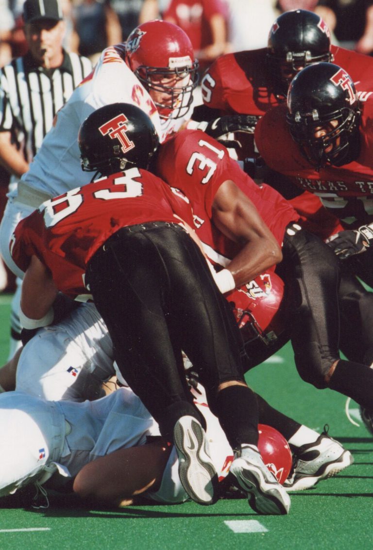 Kevin Curtis, number 31, joining Texas Tech teammates in a crowded defensive stop