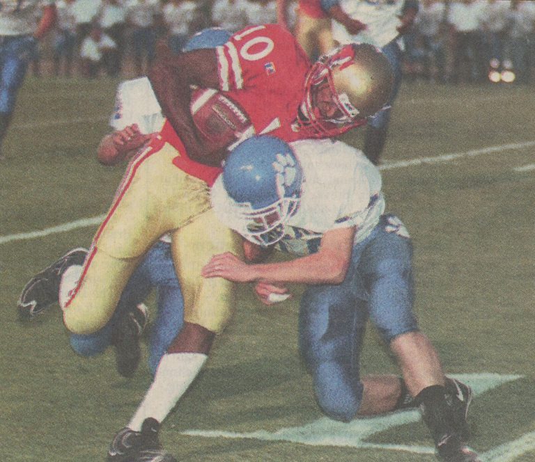 Coronado quarterback Kevin Curtis colliding with Frenship linebacker Beau West, from a newspaper photo