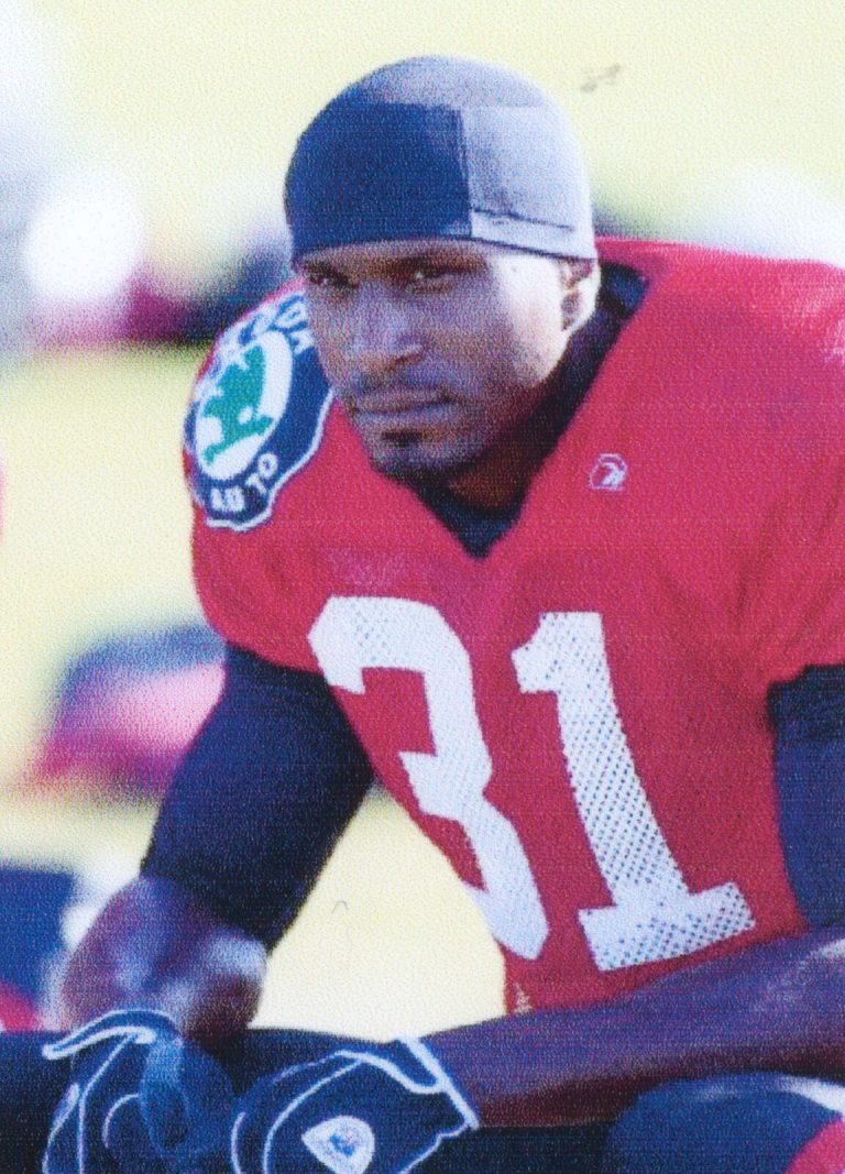 Kevin Curtis leaning forward in a red number 31 jersey and skull cap