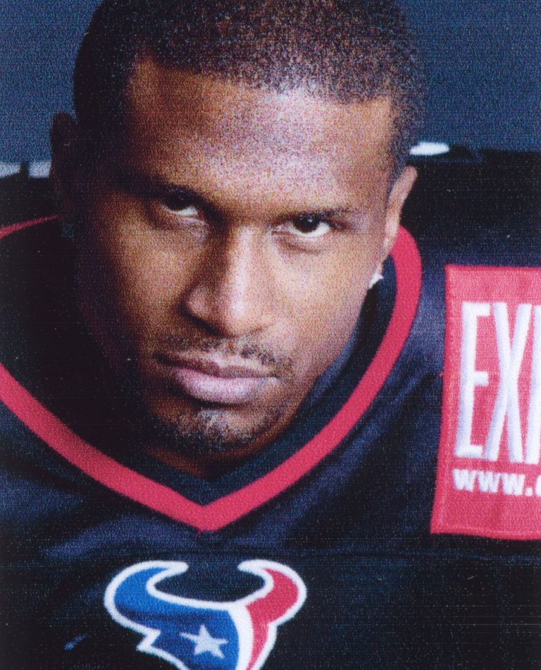 Kevin Curtis in a close-up wearing a navy jersey with the Houston Texans bull logo