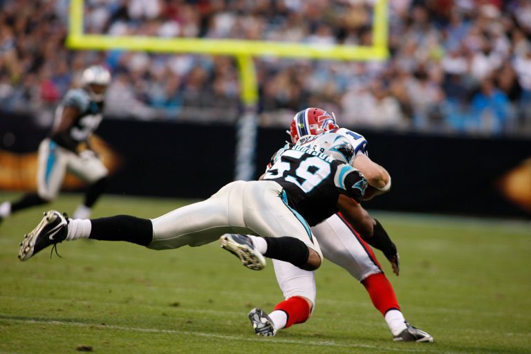 Landon Johnson, No. 59 for the Panthers, diving to tackle a Buffalo Bills ball carrier