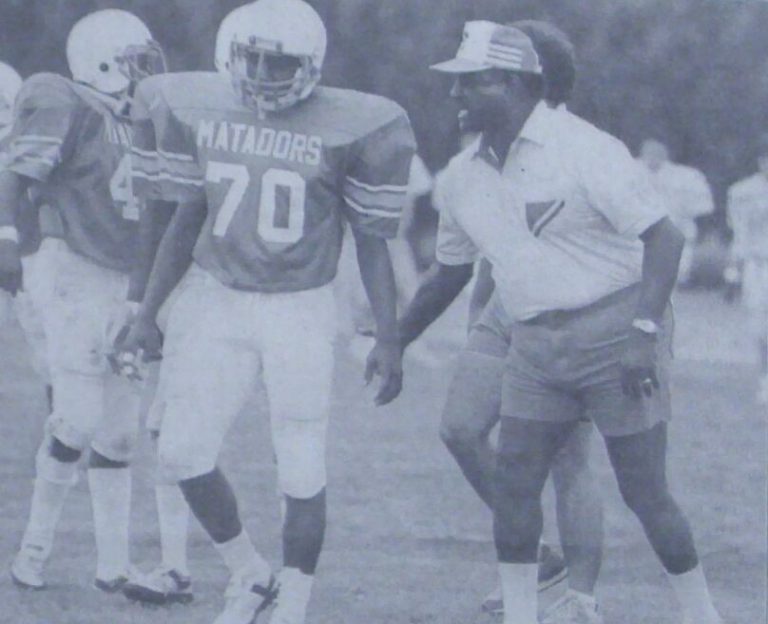 Louis Kelley in a visor instructing Matadors players at a 1985 practice, from a newspaper
