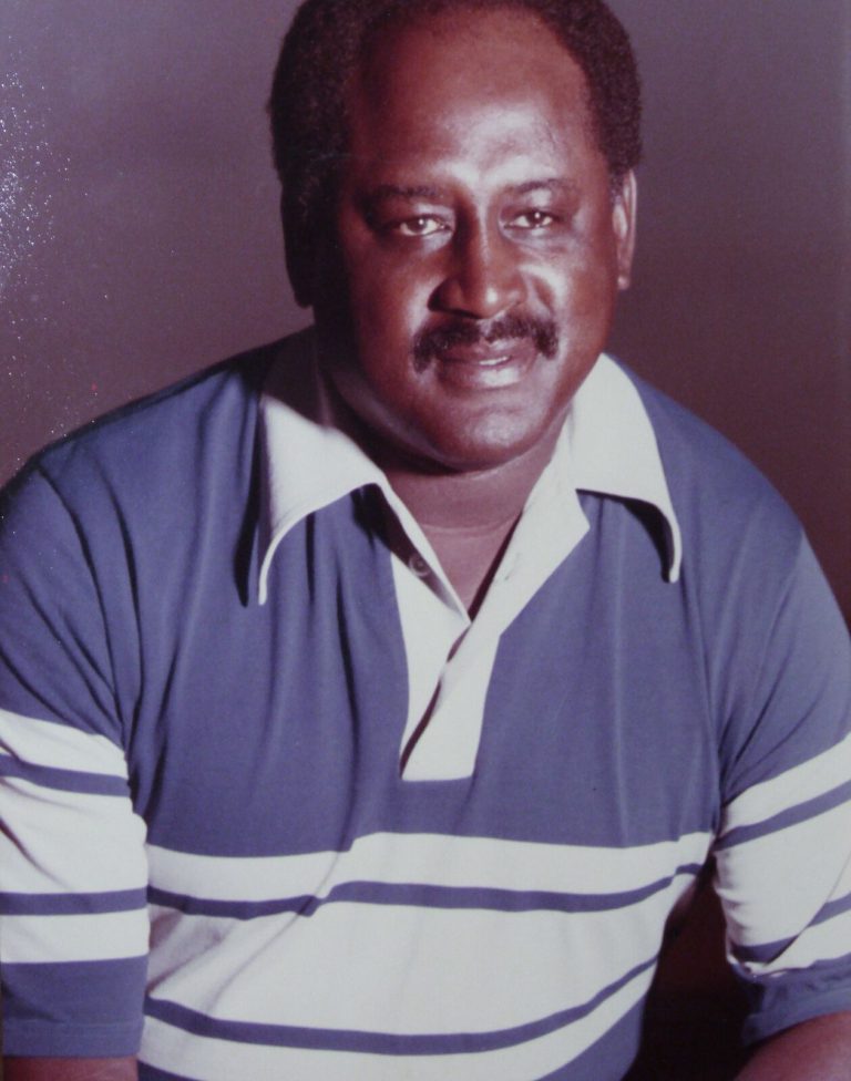 Louis Kelley in a blue and white striped polo shirt in a color portrait