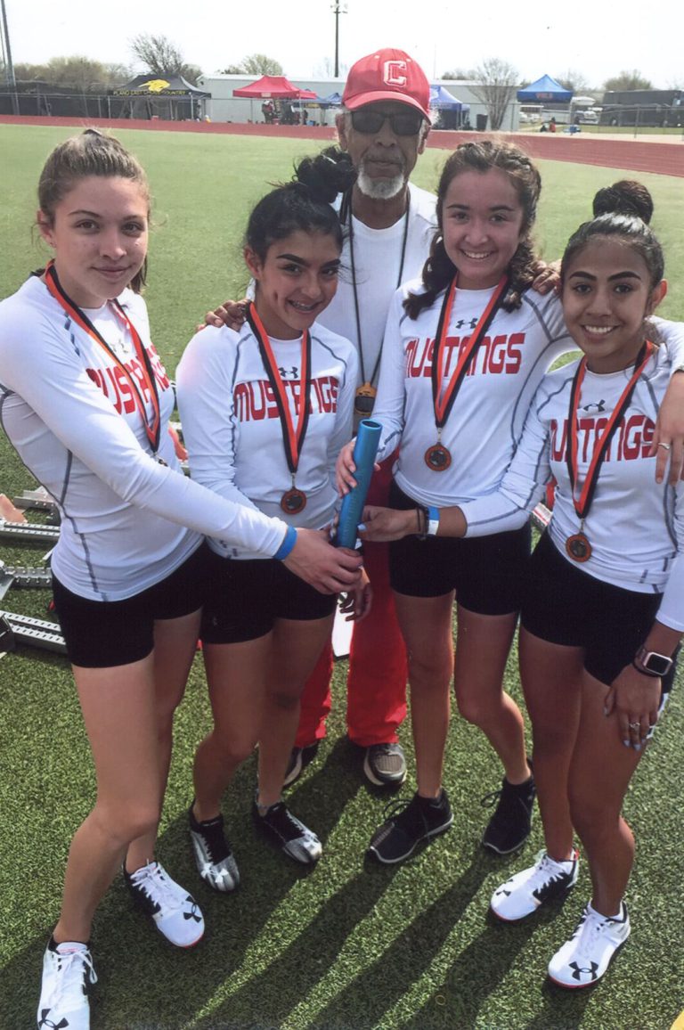 Melvin Houston's Coronado Mustangs runners posed together wearing medals