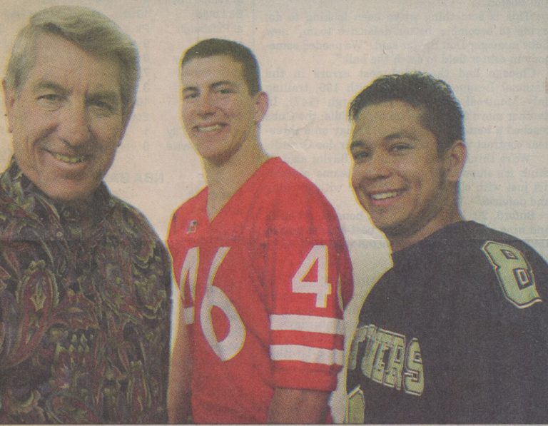 Mike Smith, center in a red number 46 jersey, with Frenship coach Bobby Davis and Lubbock High quarterback Matt Porras