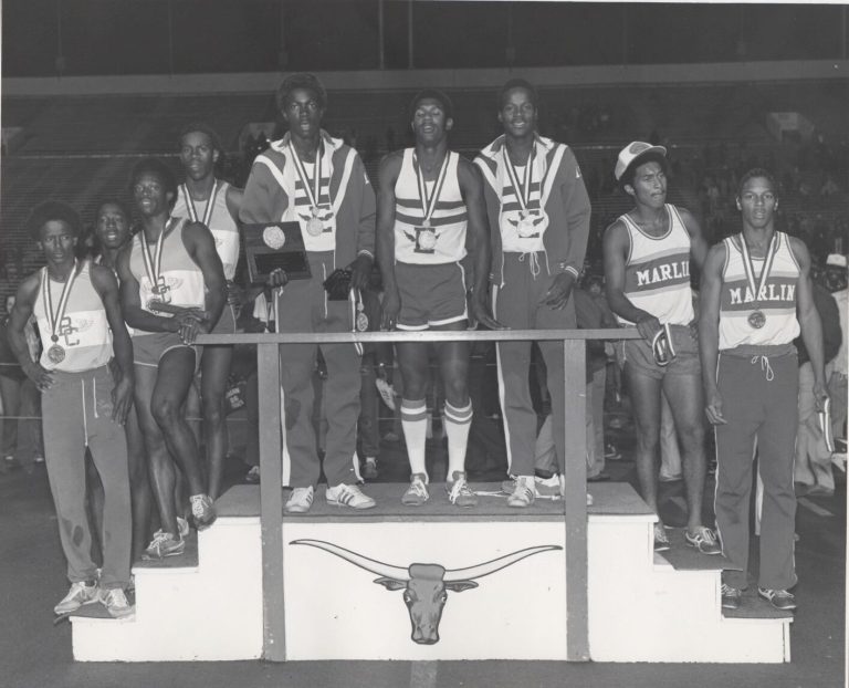 Relay runners with medals and a plaque on a Longhorn podium beside Marlin runners, from Percy Hines' collection