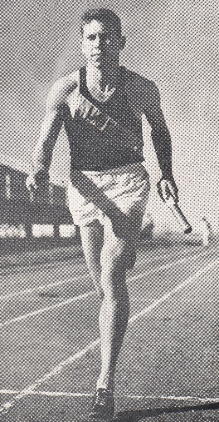Track runner holding a relay baton in a sashed uniform, black-and-white photo from the Pete Ragus collection