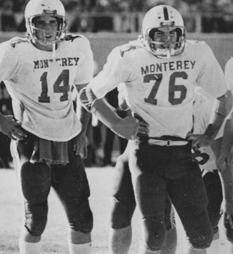 Ron Reeves in a Monterey number 14 jersey standing beside teammate number 76 on the field