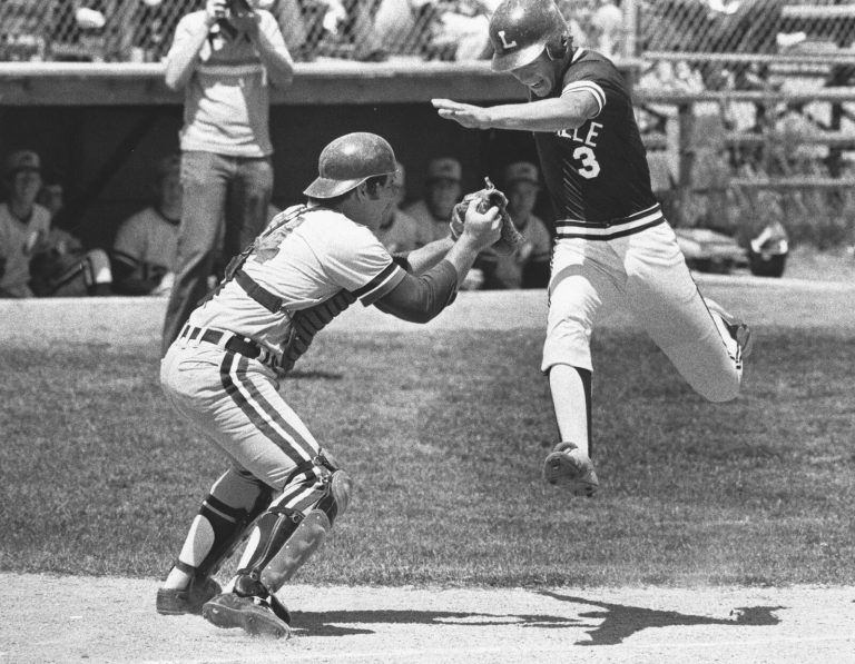 Baseball catcher reaching to tag a leaping runner, from the Steve Coleman collection