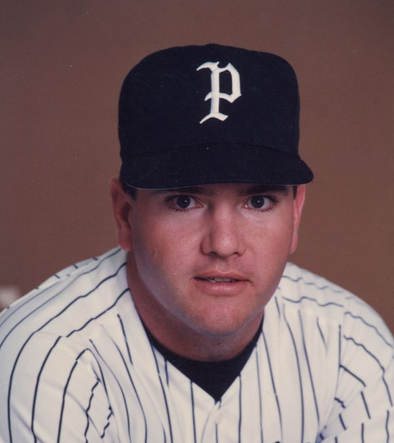 Steve Coleman in a pinstriped baseball uniform and dark cap with a P in a color portrait