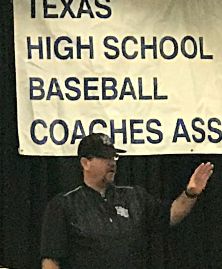 Steve Coleman speaking in front of a Texas High School Baseball Coaches Association banner