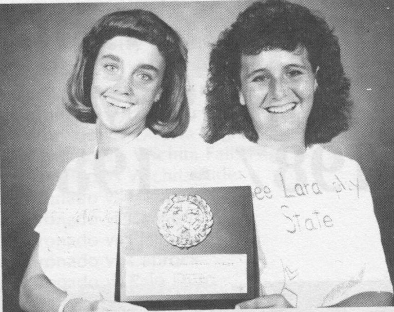 Tanya Hamilton Bryant and Lara Mahaney holding a state doubles championship plaque, from a yearbook