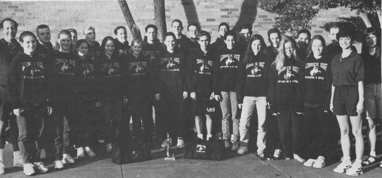 Thomas Klement with the 1994-95 Lubbock High swimming and diving team posed outdoors in matching hoodies, from a yearbook