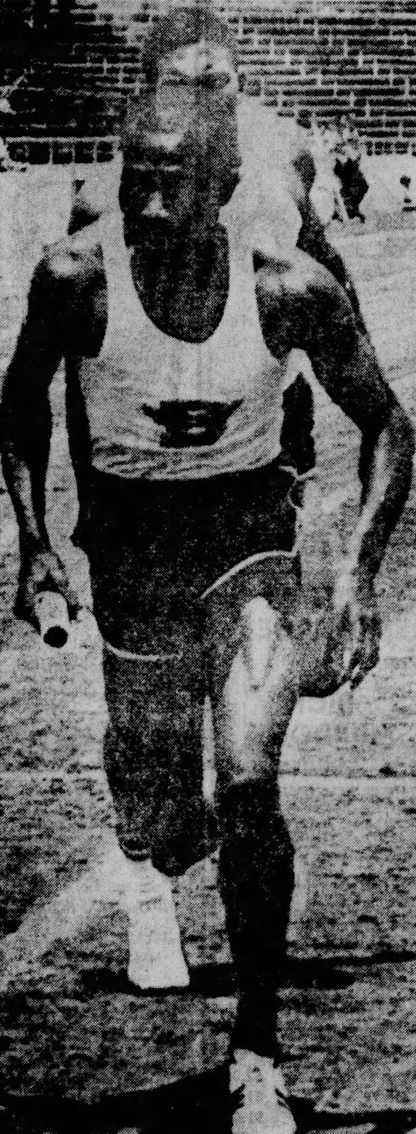 1968 State Champion Track Team runner Wayne Davis running with the baton on the mile relay, from a 1968 newspaper