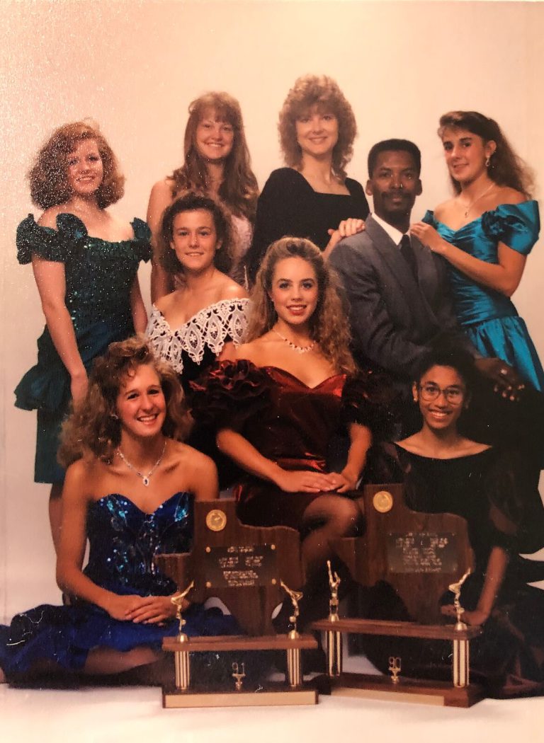 1989–90 and 1990–91 State Champion Gymnastics Teams: gymnasts in formal dresses with a man in a suit and two trophies