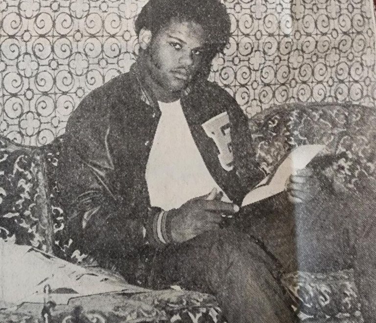Victor Hicks in an Estacado letter jacket reading a recruiting letter on a couch, from a 1974 Avalanche-Journal clipping