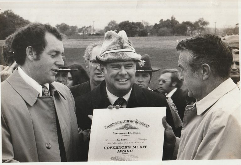 Ron Holihan with Coach Combs and the Kentucky governor at a Governor's Merit Award presentation