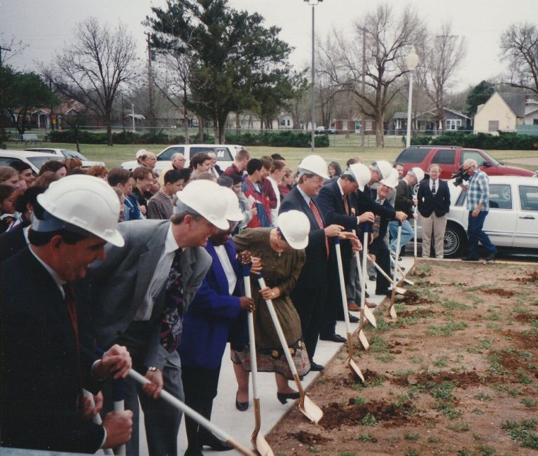 Coach Ron Holihan and school board members break ground with ceremonial shovels for the new aquatic facility