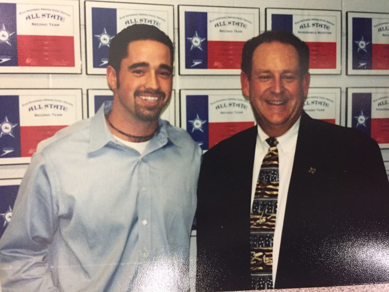 Ron Holihan with a swimmer honoree beside the All-State wall at the Pete Ragus Aquatic Center