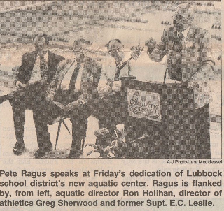 Ron Holihan, left, with Greg Sherwood and E.C. Leslie as Pete Ragus speaks at the Ragus Aquatic Center dedication