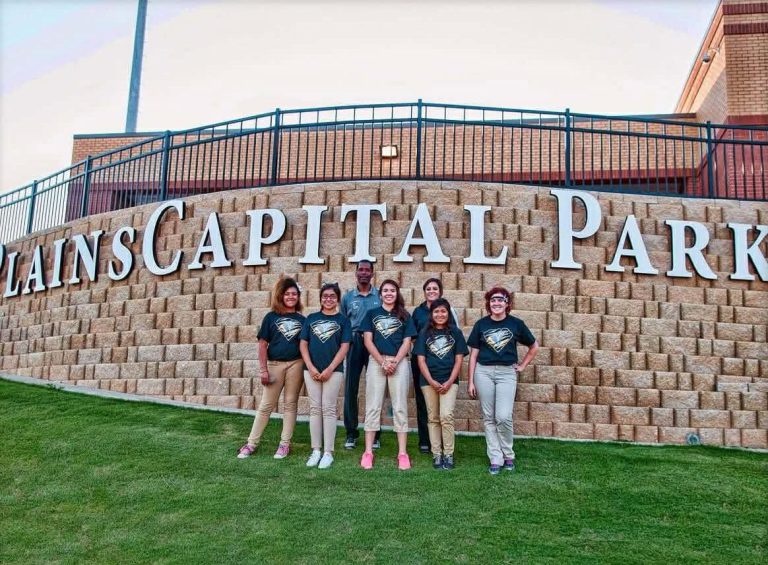 2014 Lubbock High School trainers posed in front of the PlainsCapital Park sign, from the Anthony Peppers collection