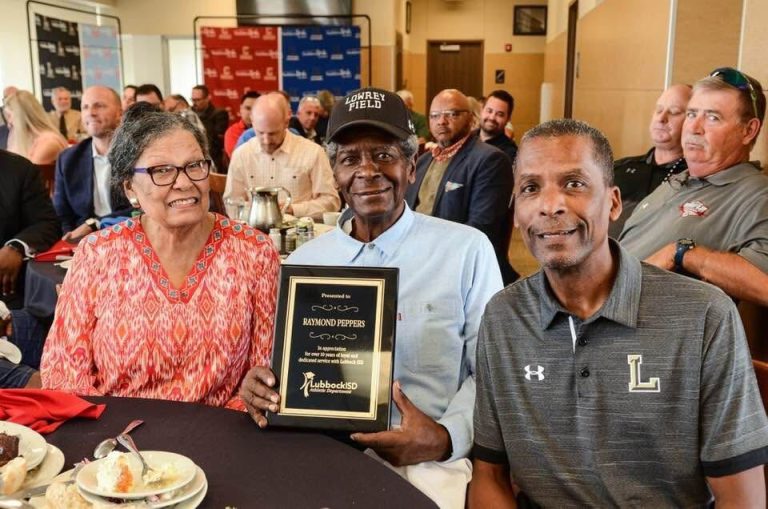 Anthony Peppers, right, at a Lubbock ISD luncheon beside a man holding a plaque presented to Raymond Peppers