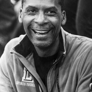 Anthony "Coach Pep" Peppers smiles in his Lubbock High Sports Medicine jacket at a game.