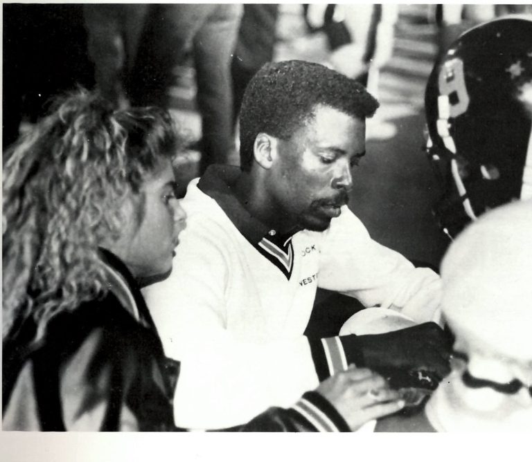 Anthony Peppers tends to a helmeted Lubbock High football player on the sideline in a 1980s yearbook photo.