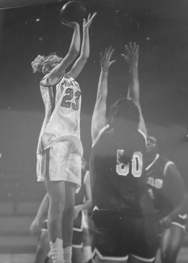 Kim Sumrall in a Monterey number 23 jersey rising for a jump shot over a defender, black-and-white game photo