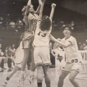 Kim Sumrall rises for a jump shot over two defenders during a Monterey Lady Plainsmen game