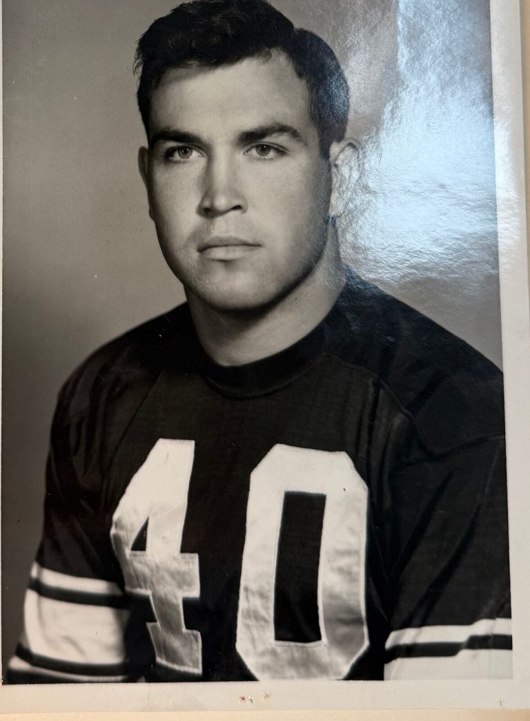 Mac Taylor in a number 40 football jersey, black-and-white studio portrait