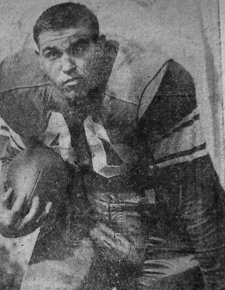 Mac Taylor in a Rice football uniform holding the ball, from a newspaper clipping