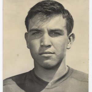 Black-and-white portrait of Mac Taylor in his Lubbock High football jersey, around 1950