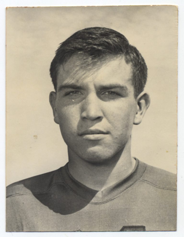 Black-and-white portrait of Mac Taylor in his Lubbock High football jersey, around 1950