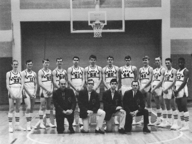 Duncan basketball team and four men in suits kneeling in front, from the Robert “Prof” Ramos scrapbook