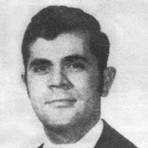 A young Robert Ramos in a suit and tie in a newspaper photo from early in his athletic training career.