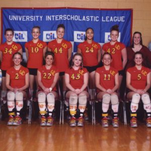 The Coronado Lady Mustangs volleyball team and coaches pose in front of a UIL banner in the mid-2000s.