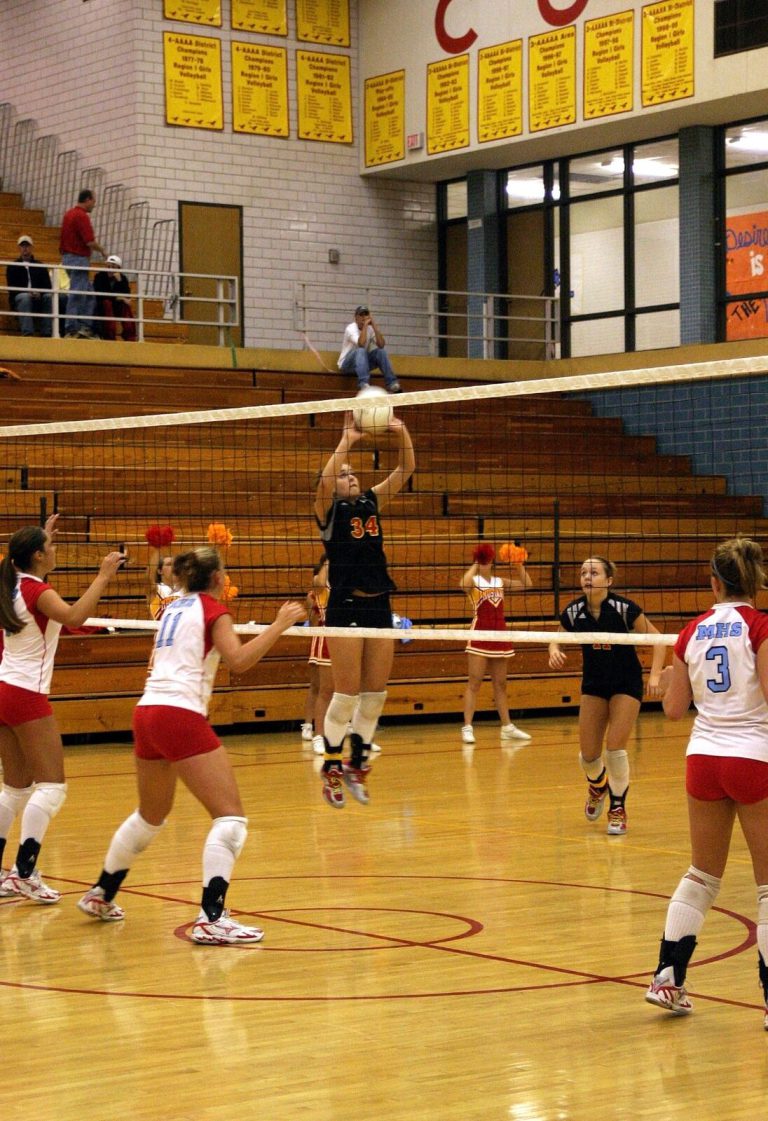 Robyn Smith Everson in a black number 34 jersey setting the ball over the net