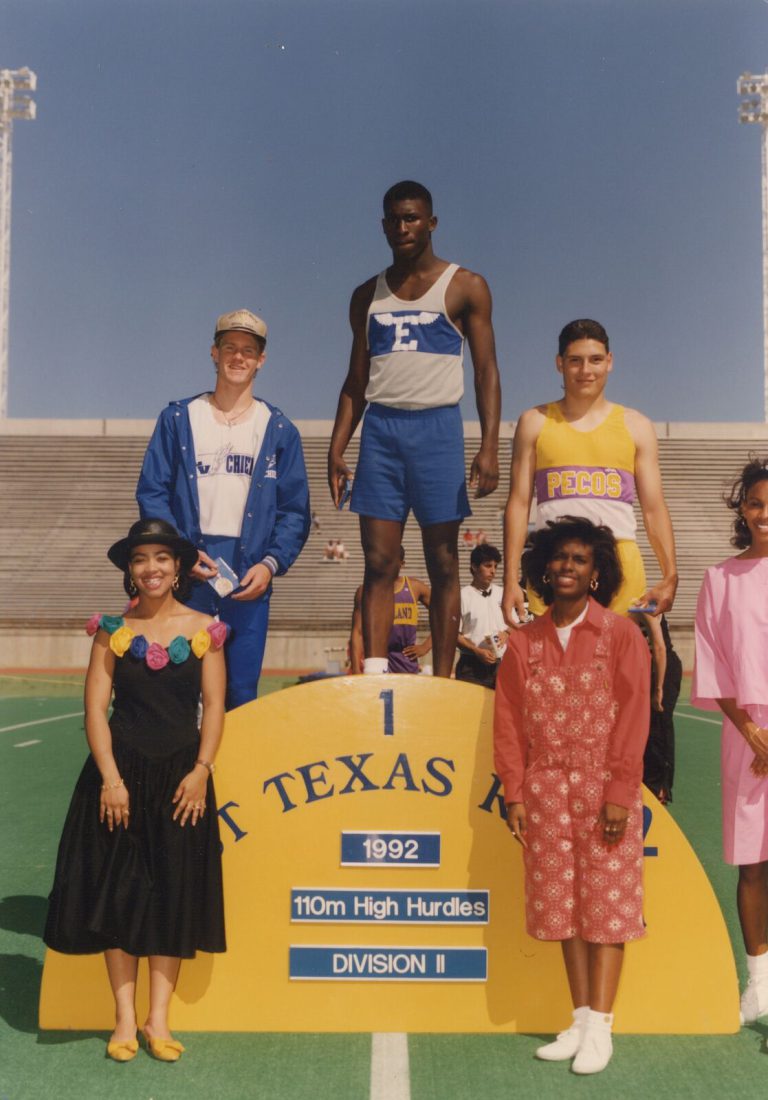 Taje Allen on the first-place step of the West Texas Relays 110m high hurdles podium, with two other medalists