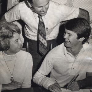 Tim Leslie signs with the Lubbock Christian Chaparrals as his mother and coach look on.