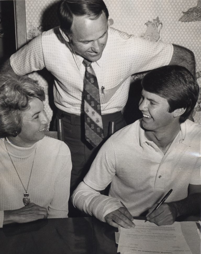 Tim Leslie signs with the Lubbock Christian Chaparrals as his mother and coach look on.