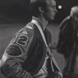 Tim Leslie in profile wearing his Monterey letterman jacket with a 1974 district champions patch.