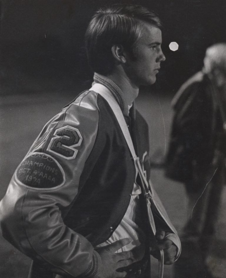 Tim Leslie in profile wearing his Monterey letterman jacket with a 1974 district champions patch.