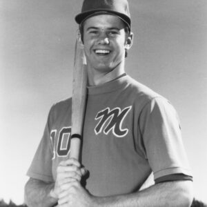 Tim Leslie smiles with a bat over his shoulder in his Monterey No. 10 baseball uniform in the 1970s.