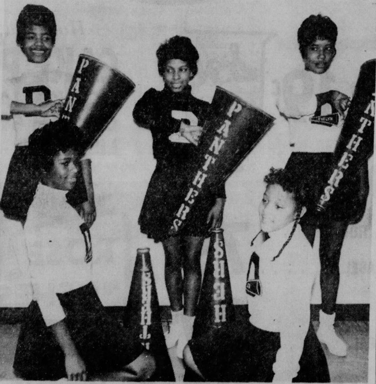 Dunbar cheerleaders with Panthers megaphones supporting the 1962 Dunbar State Champion Boys Basketball Team, 1962 newspaper