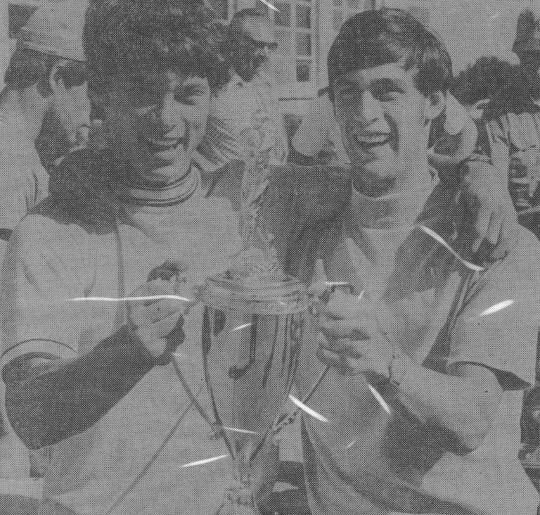 1974 Monterey State Champion Baseball Team players grinning as they hold the state championship trophy