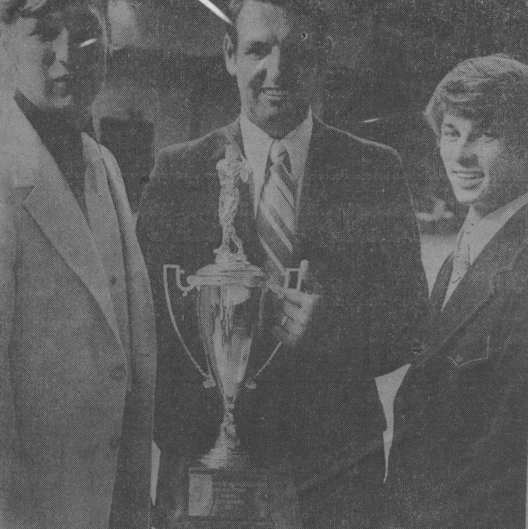 1974 Monterey State Champion Baseball Team coach Bobby Moegle holding the state championship trophy with two players
